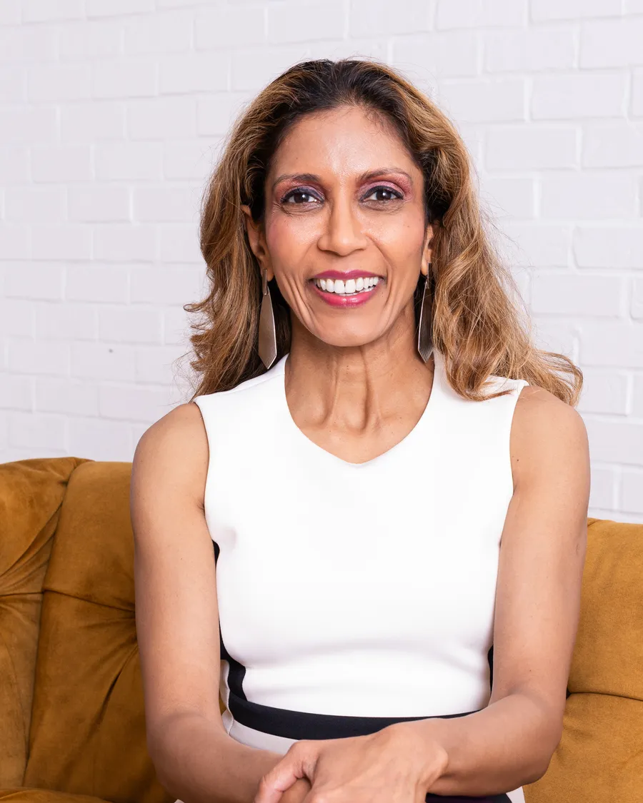 Dr. Noorhasan seated on a couch in a bright room